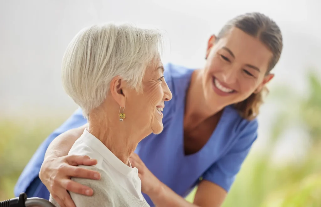 Nurse comforting an elderly woman with a hand on her shoulder