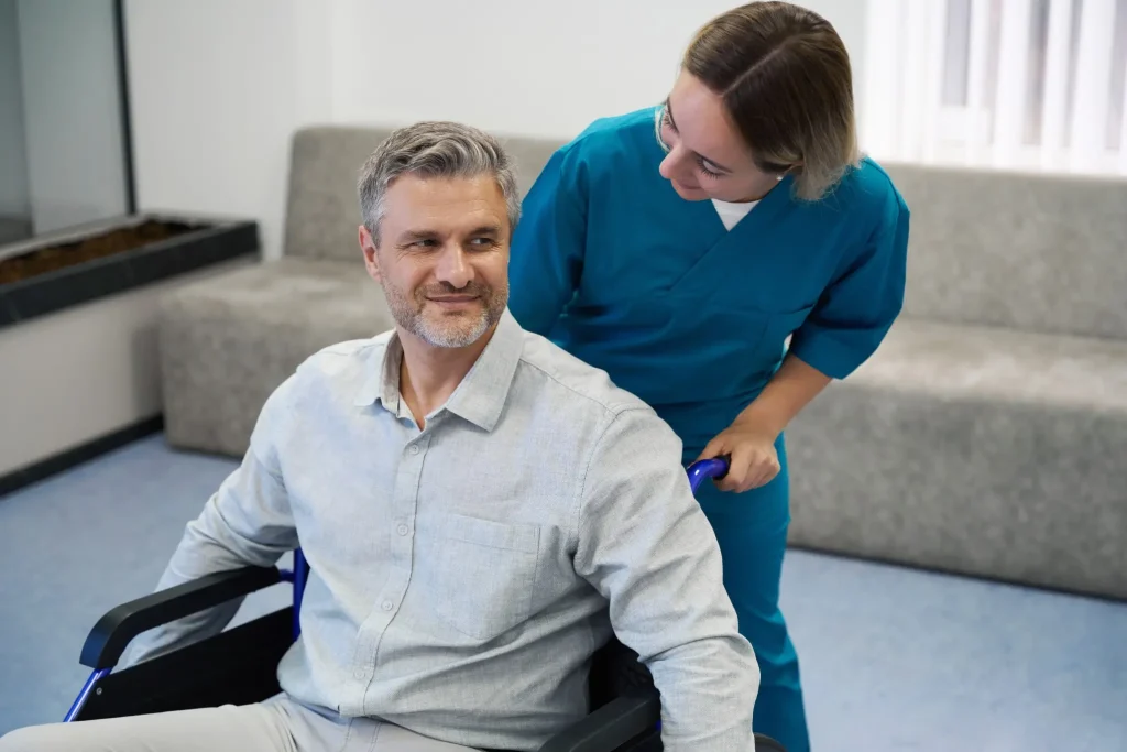 Nurse pushing a smiling man in a wheelchair